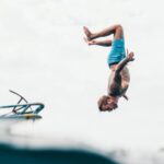 Best Dive Sites - Man Wearing Blue Shorts About to Dive on Body of Water