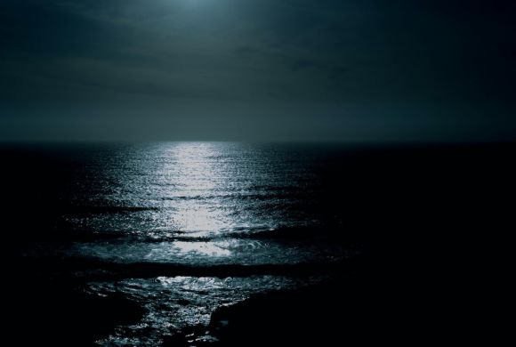 Night Sea - body of water under cloudy sky at night