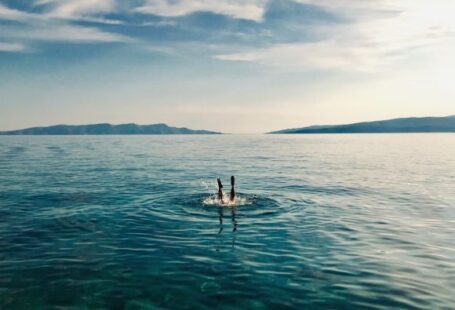 Dive - person in blue water during daytime