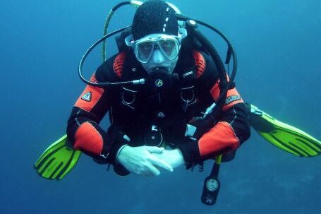 Diving - Human in Black Orange Swimming Suit in Blue Body of Water