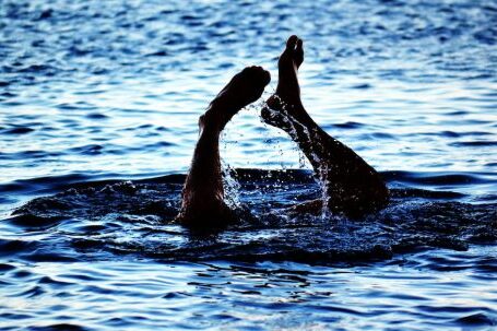 Diving - Person Swimming on Body of Water