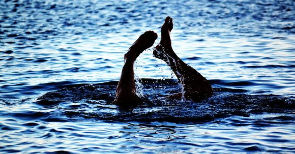 Diving - Person Swimming on Body of Water