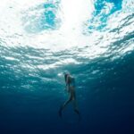 Diving - woman swimming underwater