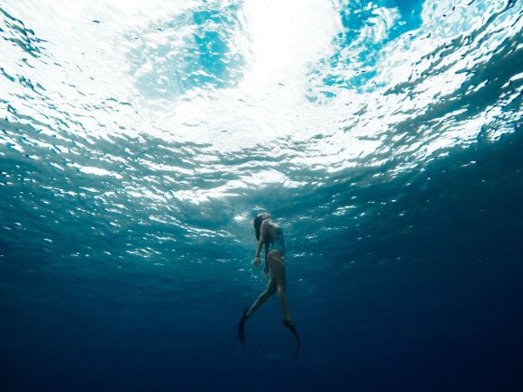 Diving - woman swimming underwater