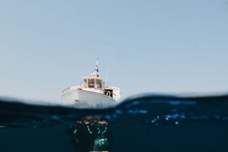 Scuba Diving - A Yacht On Sea And Man Underwater