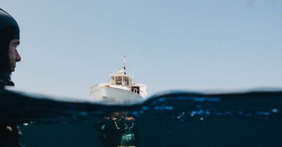 Scuba Diving - A Yacht On Sea And Man Underwater