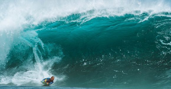 Wetsuit - Male surfer in wetsuit surfing on foamy wave splashing in turquoise sea in tropical country