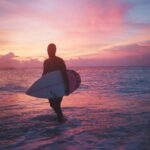 Shipwrecks - man holding surfboard