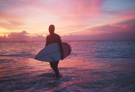 Shipwrecks - man holding surfboard