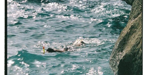 Snorkeling - Person Snorkeling near Rock on Shore