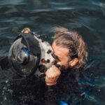Underwater Camera - Unrecognizable diver taking photo on equipment in aqua box