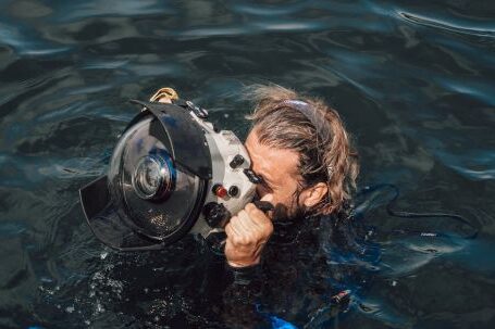 Underwater Camera - Unrecognizable diver taking photo on equipment in aqua box