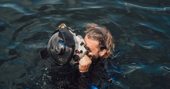 Underwater Camera - Unrecognizable diver taking photo on equipment in aqua box