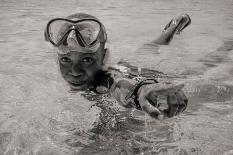 Diving Mask - A Boy Wearing a Diving Mask Swimming in the Water