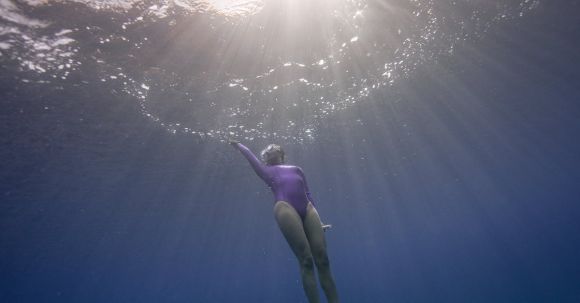 Diving Fins - A Woman Diving in the Sea 