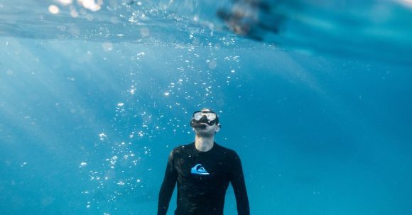 Diving Locations - Split-Level Photography of Man Underwater