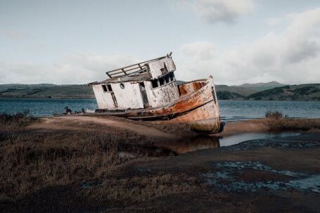 Sunken Ship - White and Rusty Boat on Seashore