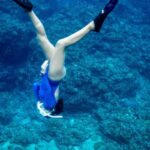 Snorkeling - A Woman Diving Towards the Sea Floor
