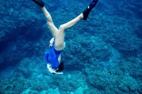 Snorkeling - A Woman Diving Towards the Sea Floor