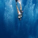 Snorkel - Unrecognizable lady swimming underwater after jumping in ocean