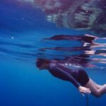 Snorkeling - Woman In Scuba Gear Swimming Under Water Close To Suface