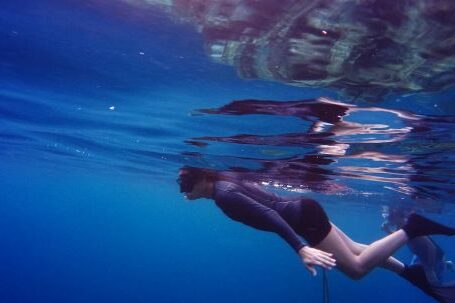 Snorkeling - Woman In Scuba Gear Swimming Under Water Close To Suface