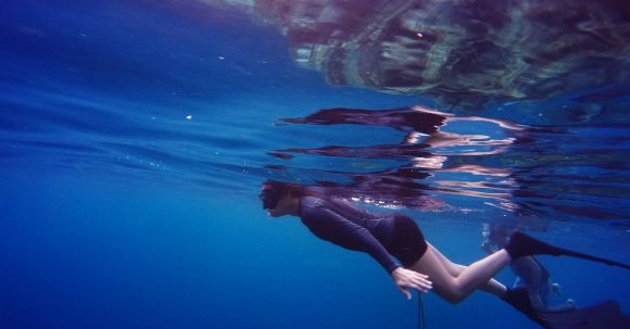 Snorkeling - Woman In Scuba Gear Swimming Under Water Close To Suface