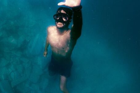 Snorkeling - A Man Wearing Diving Goggles