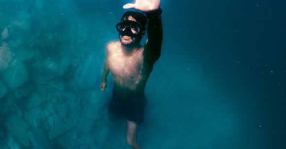 Snorkeling - A Man Wearing Diving Goggles