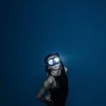 Snorkel - Unrecognizable woman diving in blue sea water