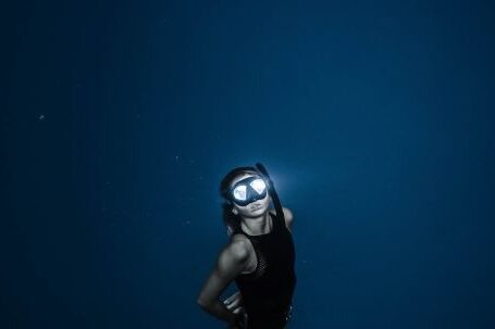 Snorkel - Unrecognizable woman diving in blue sea water