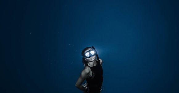 Snorkel - Unrecognizable woman diving in blue sea water