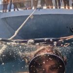 Diving Boat - Woman Underwater Taking a Picture of Herself and People on a Boat behind Her