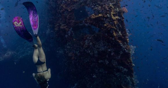 Snorkeling - Woman Swimming Underwater Near a Shipwreck
