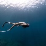 Snorkel - Anonymous graceful woman snorkeling in ocean