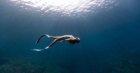 Snorkel - Anonymous graceful woman snorkeling in ocean