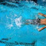Diving Locations - Person Swimming on Body of Water