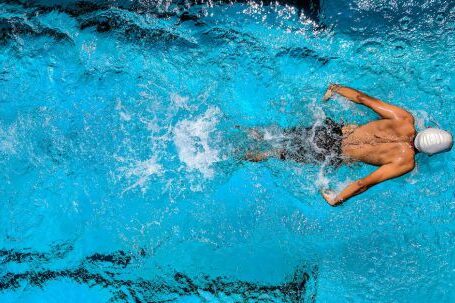 Diving Locations - Person Swimming on Body of Water