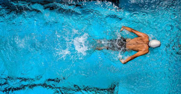 Diving Locations - Person Swimming on Body of Water