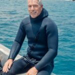 Scuba Diving - A Man in a Boat Wearing a Scuba Diving Suit