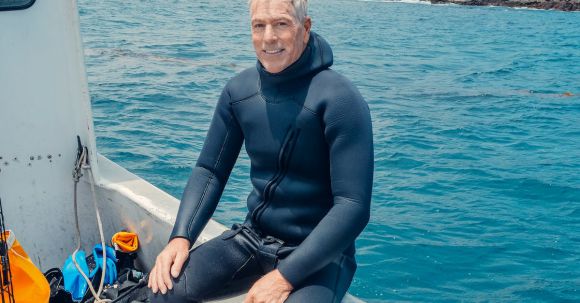 Scuba Diving - A Man in a Boat Wearing a Scuba Diving Suit