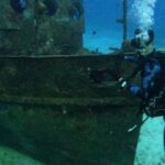 Diving Boat - A Scuba Diver Near a Sunken Boat Underwater