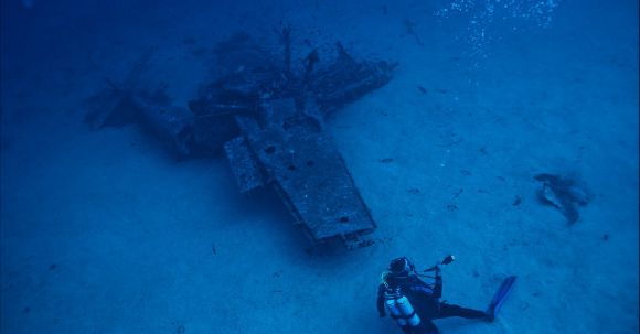 Underwater - Photo of Person Scuba Diving Near Wreckage