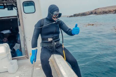 Scuba Diving - Person in Scuba Diving Gear Sitting on a Boat