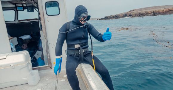 Scuba Diving - Person in Scuba Diving Gear Sitting on a Boat