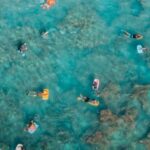 Snorkeling - Sunbathers Swimming on Air Mattresses in Sea at Coral Reef