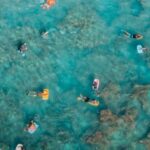 Snorkeling - Sunbathers Swimming on Air Mattresses in Sea at Coral Reef