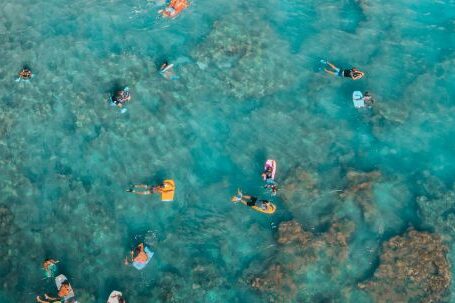 Snorkeling - Sunbathers Swimming on Air Mattresses in Sea at Coral Reef