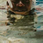 Diving Mask - A Boy Wearing a Diving Mask Swimming in the Water