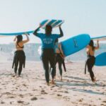 Wetsuit - Group of People Carrying Surfboards